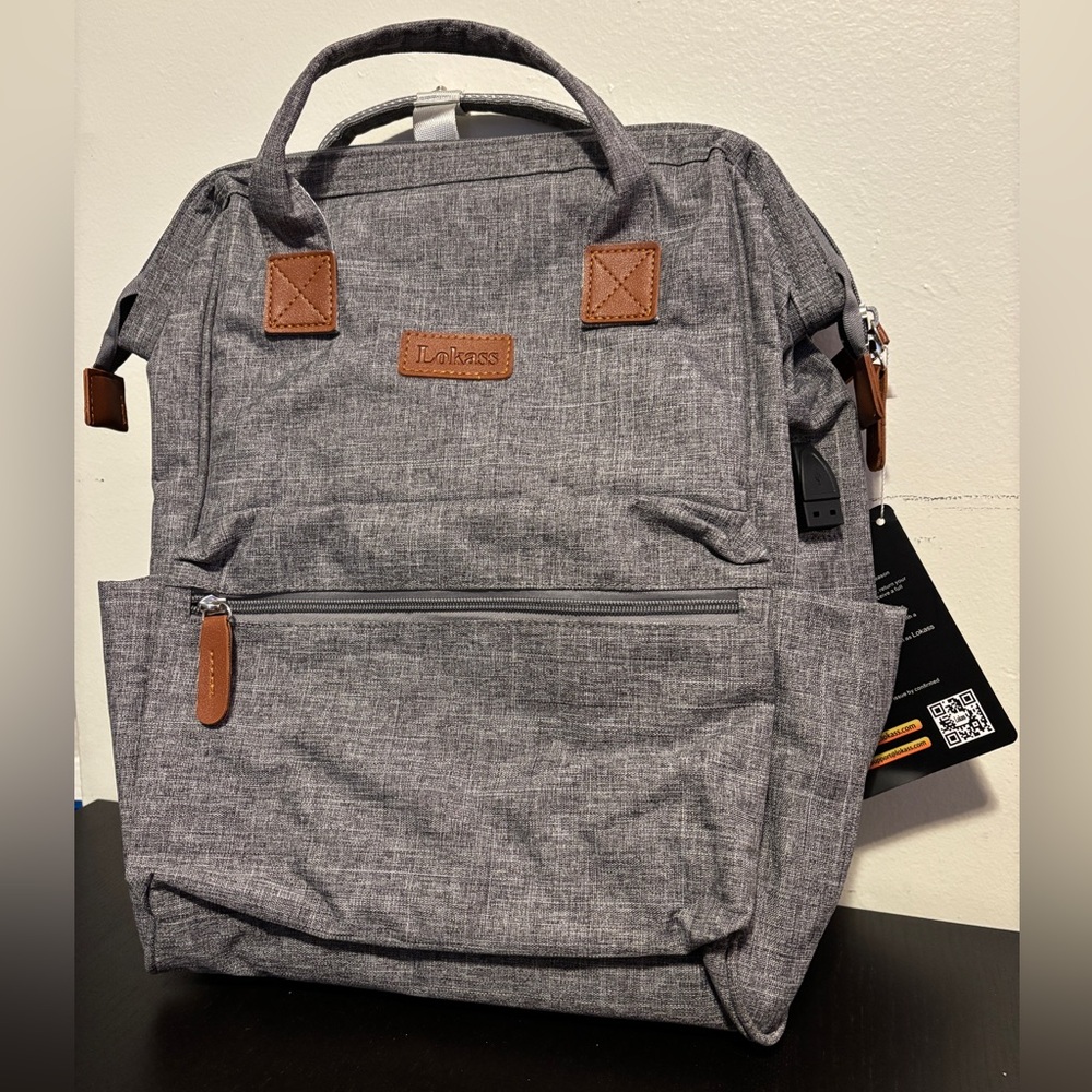 NWT Lokass backpack. Laptop pocket, USB charging port, water resistant.